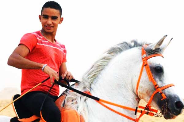 Children learning to ride horses